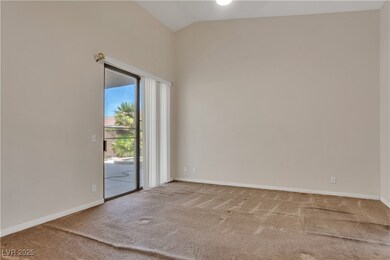 Unfurnished room with carpet, vaulted ceiling, and