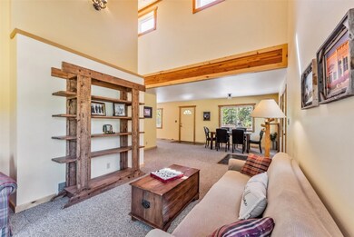 Living room with carpet and a towering ceiling