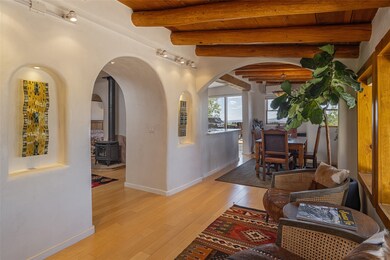 Entry Sitting Room with vigas accesses the Living & Dining Rooms