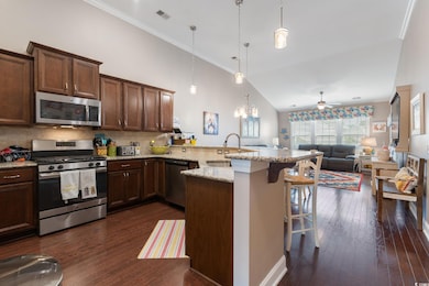 Kitchen featuring kitchen peninsula, appliances wi