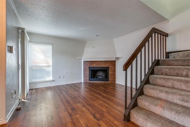 Unfurnished living room featuring a fireplace, dar