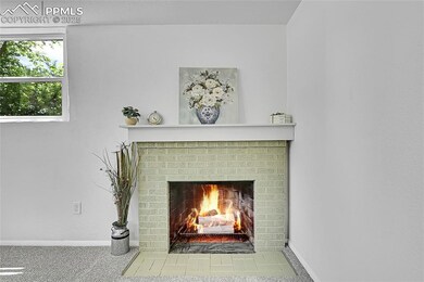 Detailed view of a brick fireplace and baseboards