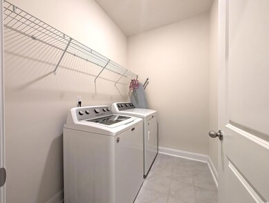 Washroom featuring light tile patterned floors and separate washer and dryer