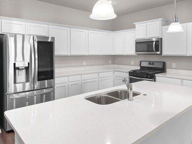 Gorgeous chef's delight kitchen with quartz countertops and SS appliances