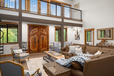 Living room with a high ceiling and wood finished floors