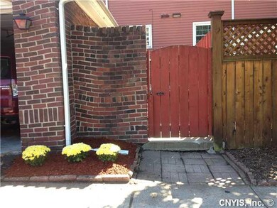Exterior Front. Front entry showing privacy gate.