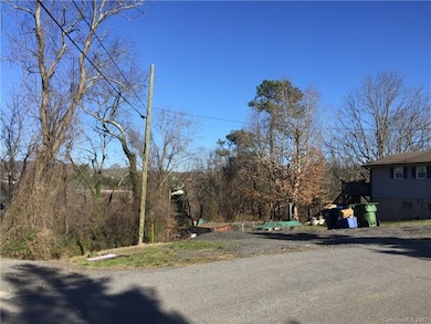 Easy build lot with paved frontage, gentle downslope