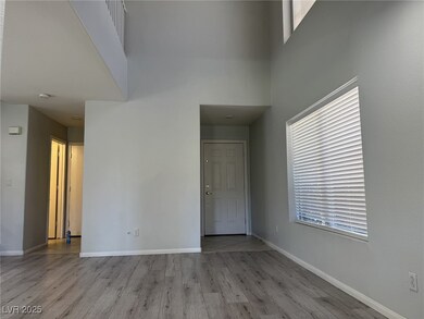 Empty room featuring wood finished floors, a high