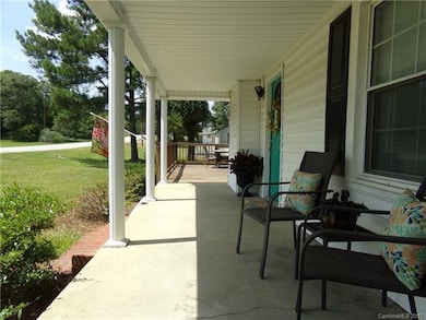 Enjoy the front covered porch that leads to the la