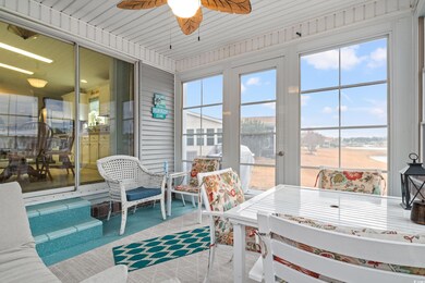 Screened in porch with water view and ceiling fan