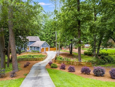 View of front facade with driveway and a garage