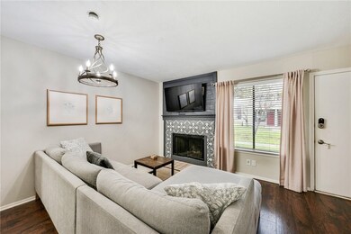 Living room featuring a tiled fireplace, dark wood