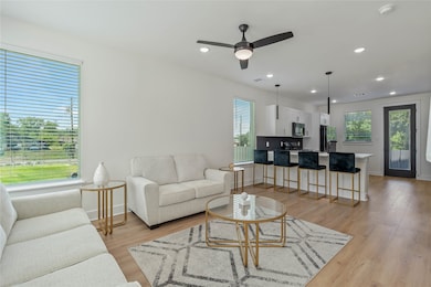 Interior view showcasing the open-concept living room and kitchen layout.