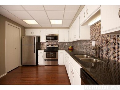 Remodeled kitchen with granite countertops, glass 