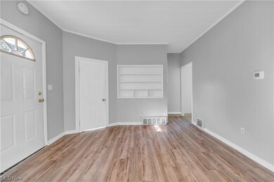 Entryway featuring crown molding and light hardwood / wood-style floors