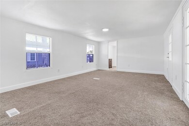 Carpeted empty room with a healthy amount of sunli