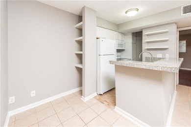 Kitchen with open shelves, white appliances, a pe