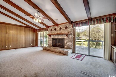 Unfurnished living room with wood walls, lofted ce