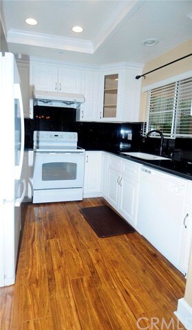 Kitchen with newer white appliances,cabinets,black