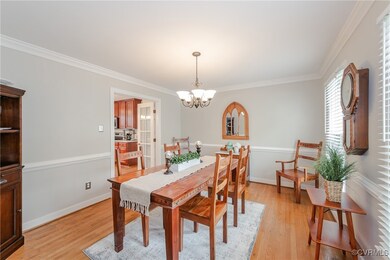 Dining area with ornamental molding, baseboards, a