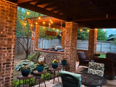 Fenced backyard with a patio area, a grill, and outdoor dining area