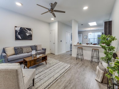 Living area with ceiling fan, recessed lighting, 