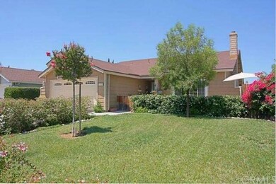 Large front lawn that is behind the privacy hedge.