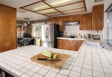 The chef in the family is going to truly appreciate the well-appointed kitchen’s abundant wood cabinets, handy pantry, tile counters with full back-splash, dual basin sink, dishwasher, ceramic cook-top with ventilation hood, microwave, double oven, c