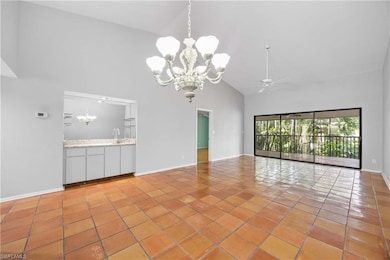 Combined living room and dining room open to huge covered lanai via collapsing sliders sliders.  Soaring vaulted ceilng!