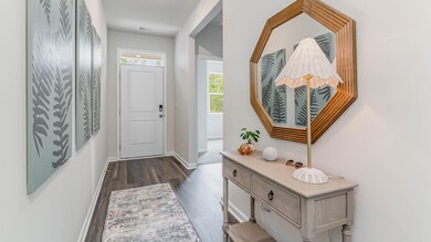 Doorway featuring dark wood-style floors, visible 