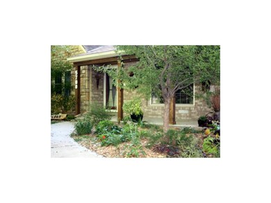 Gorgeous front porch nestled in the lush landscapi