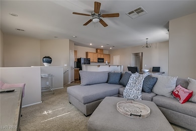 Living room featuring ceiling fan, light colored c