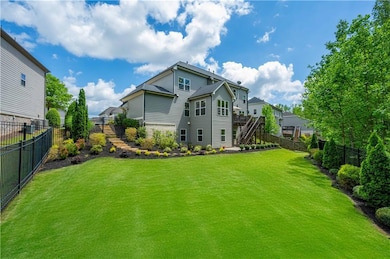 Rear view of property featuring stairs, a fenced backyard, and a wooden deck