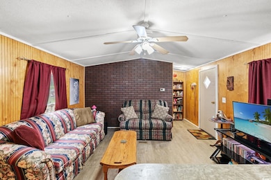 Living area featuring wooden walls, wood finished 
