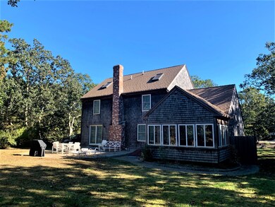 Rear view showing patio, outdoor shower and 3 season porch