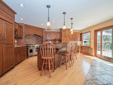 Custom chef's gourmet kitchen w/huge center island, breakfast bar, dual oven/range, lots of storage, & breakfast room.