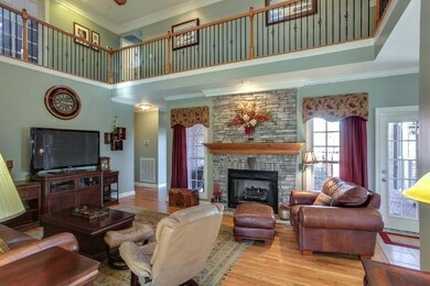 The two-story Great Room is cozy yet open in this expansive floor plan and has an impressive stacked stone Fireplace.