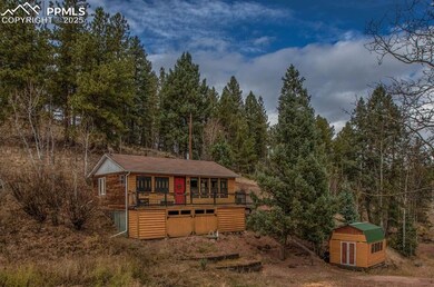 View of shed with a wooded view