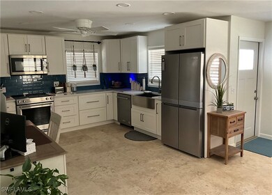 Kitchen featuring a sink, ceiling fan, tasteful ba