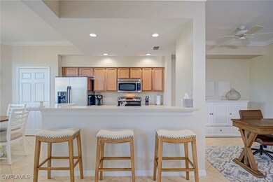 Kitchen with crown molding, a breakfast bar, and stainless steel appliances
