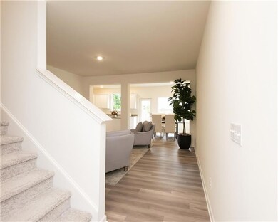 Staircase with wood finished floors and recessed lighting