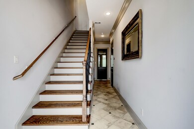 Inviting foyer with travertine designed flooring w