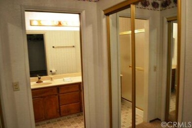 The master bathroom suite has mirrored closet door