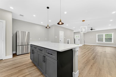  This chef-inspired kitchen features a massive island, pendant lighting, and plenty of room for barstools — ideal for meals, mingling, and making memories.