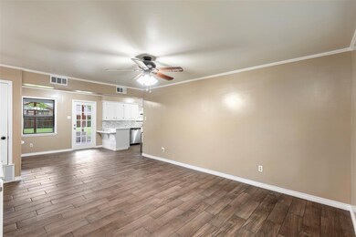 Unfurnished living room with light wood-type flooring, crown molding, and ceiling fan