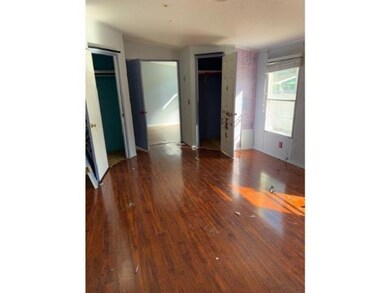 Unfurnished bedroom with multiple closets and dark