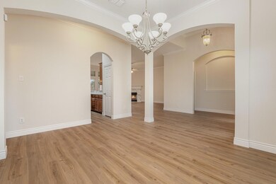Spare room with crown molding, light wood-style fl
