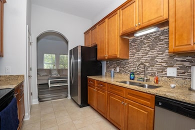 Kitchen featuring tasteful backsplash, light tile 