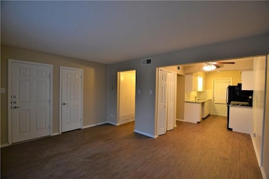 Unfurnished living room featuring dark wood finish