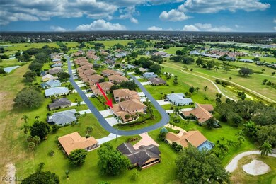 Aerial perspective of suburban area featuring a golf club and a nearby body of water